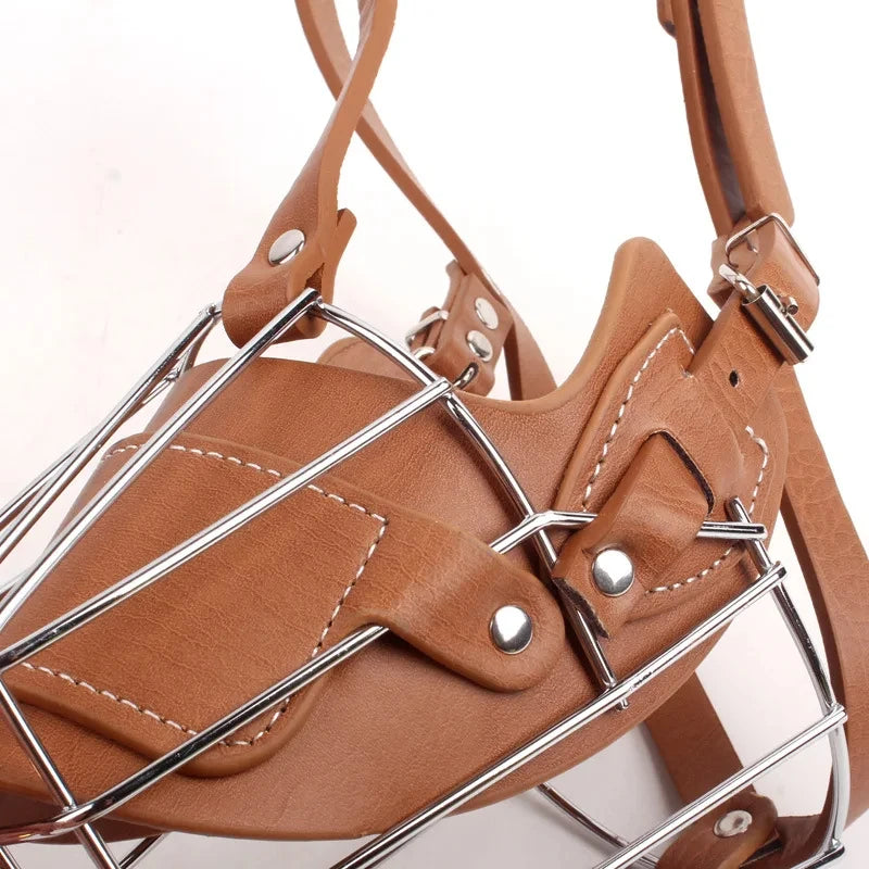 A brown leather dog muzzle with a metal frame is shown from above.