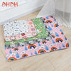 A colorful washable pet training mat for dogs featuring various patterns including rainbows and clouds