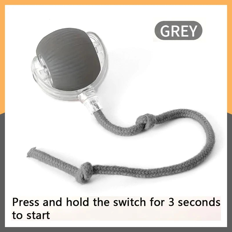 A grey interactive auto-roll cat ball with a faux mouse tail is shown, ready to be pressed and held to start.