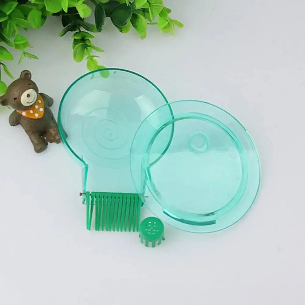 A clear plastic aquarium snail catcher with a green brush and a small trap for catching snails.
