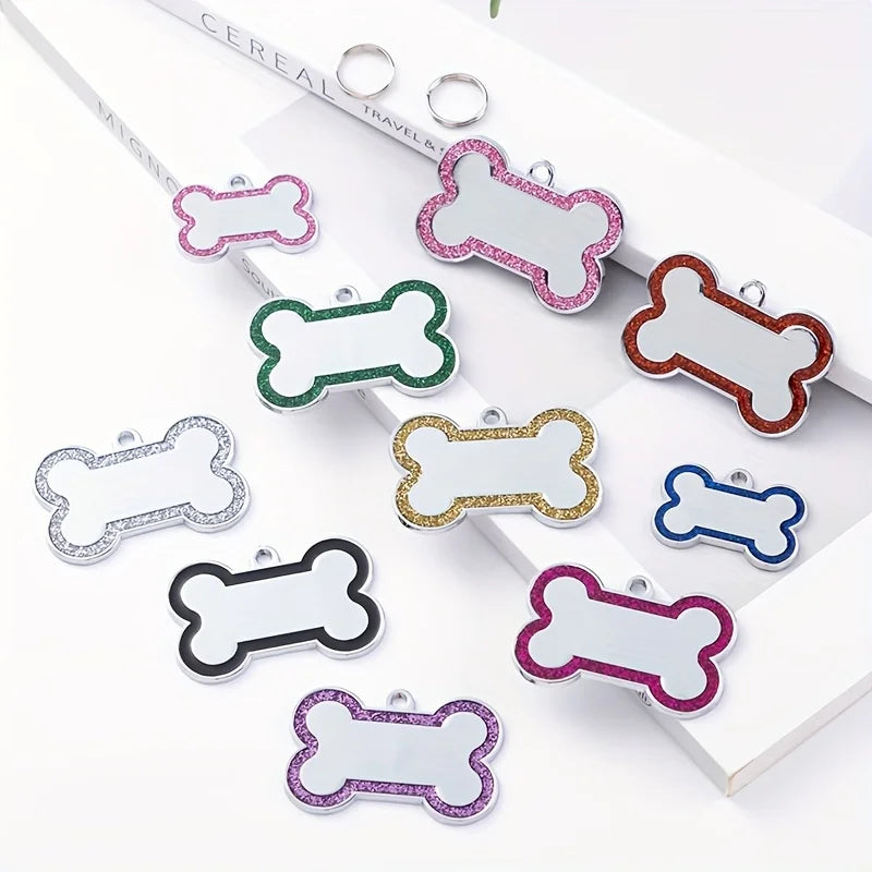 A collection of personalized engraved pet ID tags in various shapes and colors for dog and cat collars.