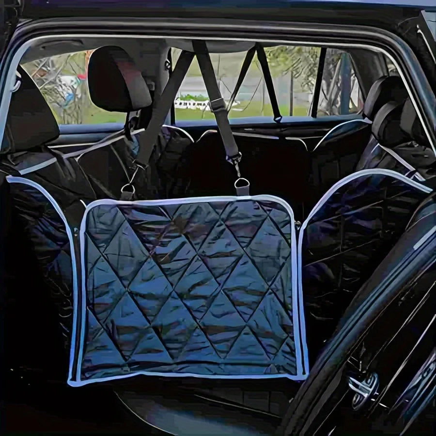 A quilted black waterproof dog backseat cover installed in a car interior.