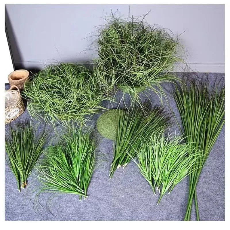 A collection of green simulated onion grass used for garden decoration, displayed on a gray surface.