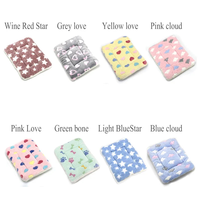 A collection of colorful plush fleece pet blankets and mats featuring various patterns like stars, clouds, and solid colors.