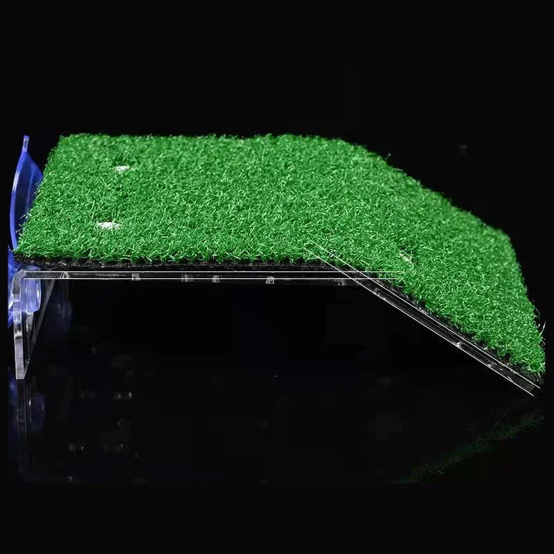A green artificial grass ramp platform with suction cups is shown against a dark background.