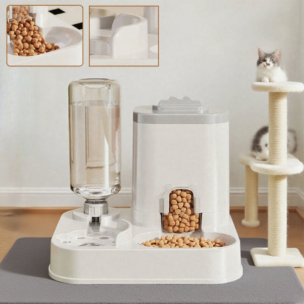 A white automatic pet water and food dispenser with glass water and kibble compartments on a gray mat.