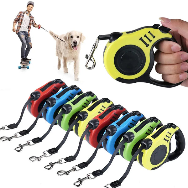 A hand holds a yellow and black retractable dog leash with multiple colored grips and attached leashes.