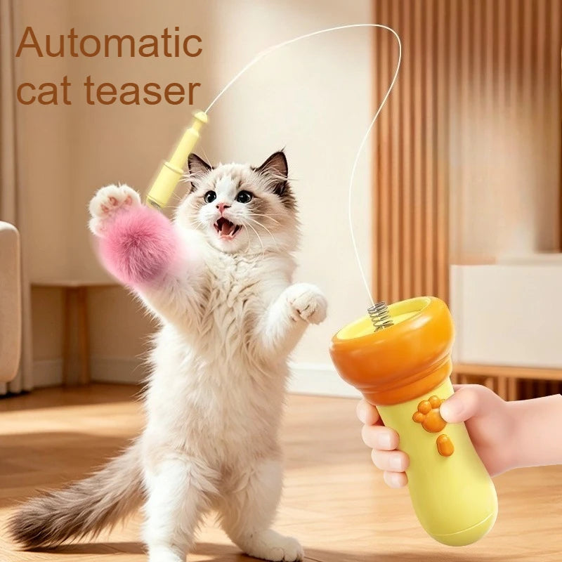 A fluffy white cat is playing with an electric interactive cat teaser wand toy.