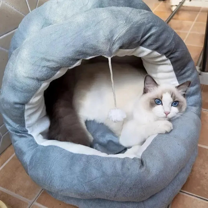 A fluffy gray cat nest bed with a hood, featuring a white and gray cat resting inside.