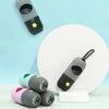 A collection of small, capsule-shaped dog waste bag dispensers in various colors and a flashlight.