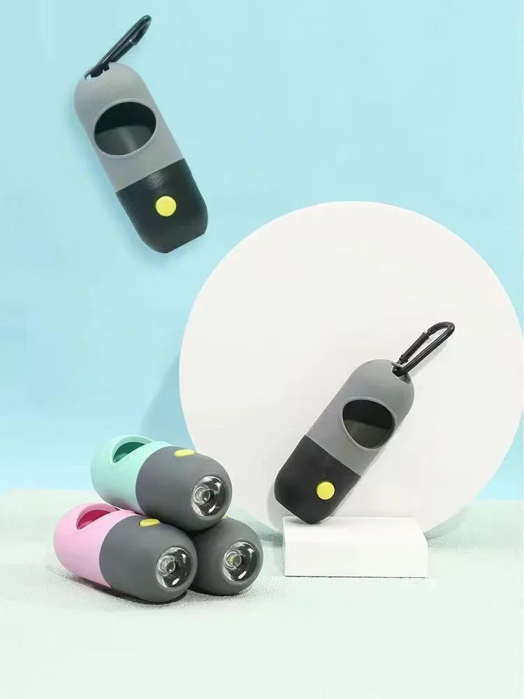 A collection of small, capsule-shaped dog waste bag dispensers in various colors and a flashlight.