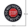 Black embroidered patch with red text STOP DO NOT DISTRACT DO NOT PET on a hexagonal background