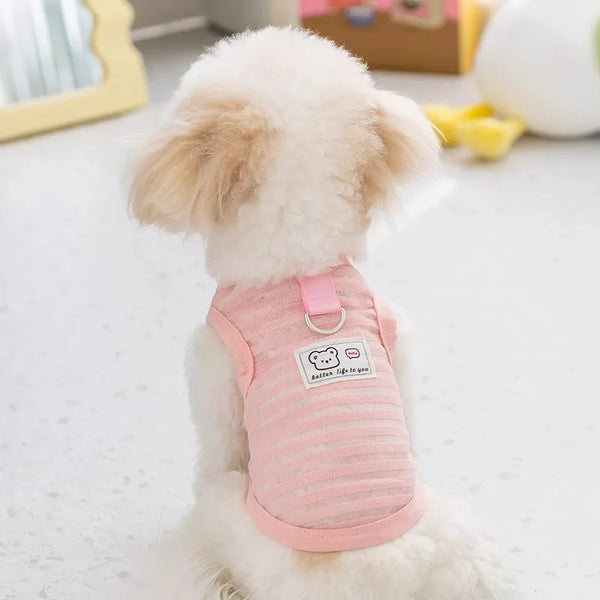 A light pink breathable mesh pet vest for a fluffy white dog, shown from the back.