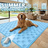 A blue cooling mat for dogs is placed on a tile floor in a modern living room setting.