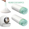 Rolls of heavy-duty cat litter box liners with drawstring visible alongside a white litter box.