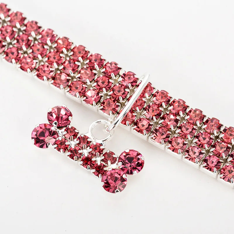 A pink crystal rhinestone dog collar featuring a quick release buckle and a textured band.