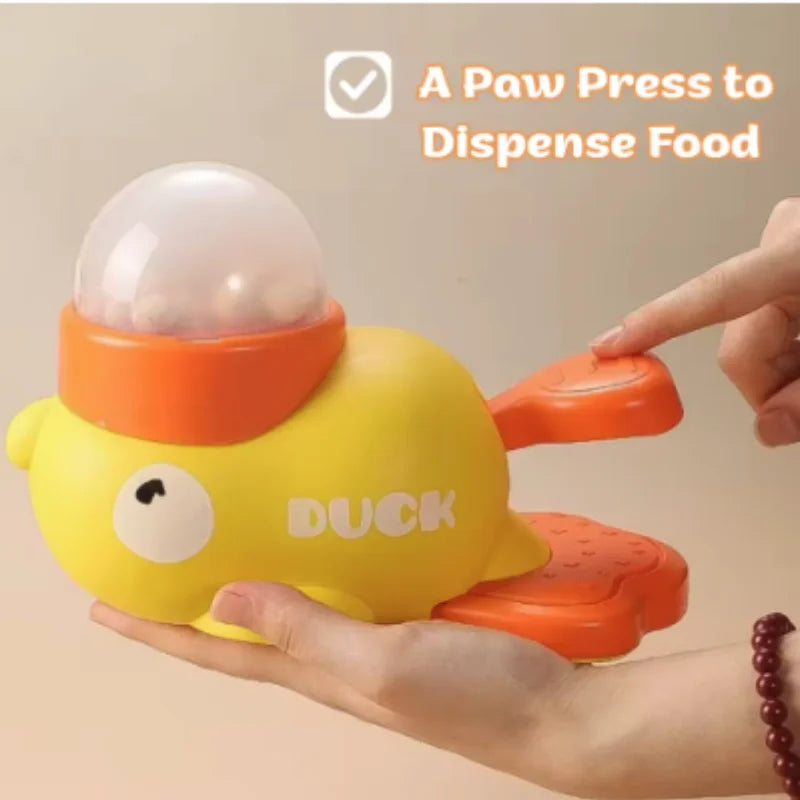 A yellow duck-shaped paw press toy designed to dispense food for pets.