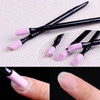 A set of black nail file cuticle pusher and buffer tools with light purple tips shown on a finger.