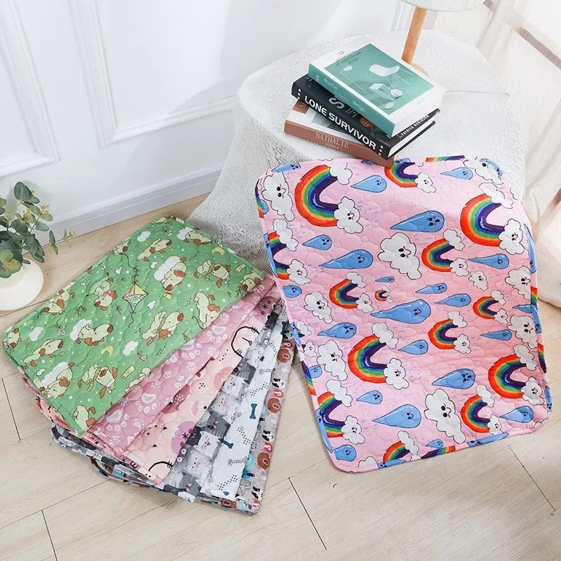 A pink and green patterned washable pet training mat for dogs is displayed on a white table.