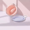A pink silicone pet travel bowl with a textured interior and a light purple silicone bowl are displayed on a white surface.