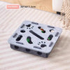A gray square interactive felt puzzle toy for cats with various holes and shapes.