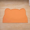 An orange silicone cat face pet feeding mat designed for food and water bowls.