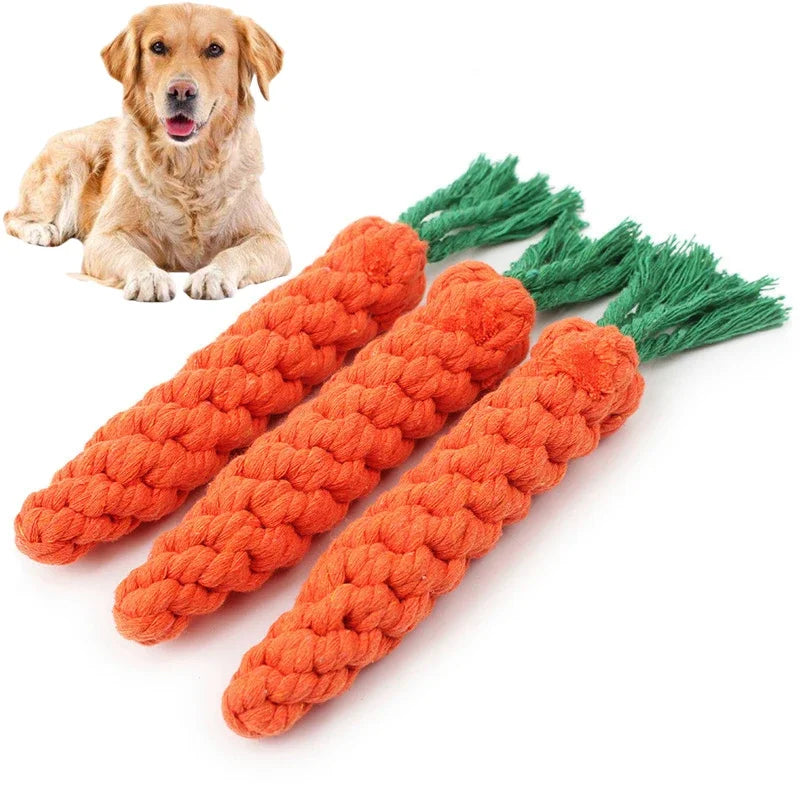An orange cotton rope dog toy set featuring carrot and dumbbell shaped toys with green tassels.