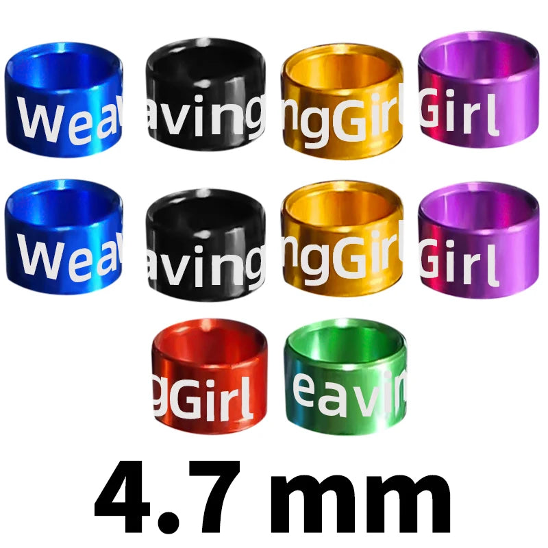 Assorted metal bird identification rings in various colors including blue, black, gold, and purple.