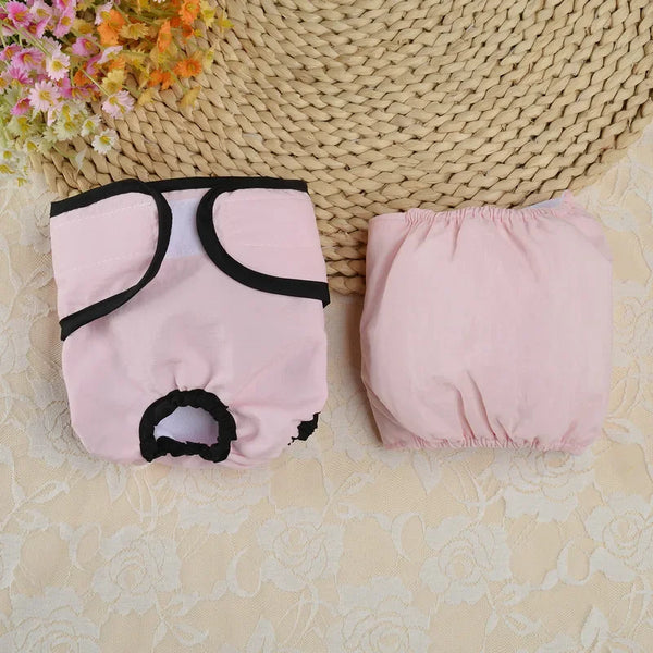 Pink reusable dog diapers with adjustable fit shown on a light surface.