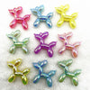 A collection of colorful acrylic balloon dog charms in various shades including pink, blue, yellow, and green.
