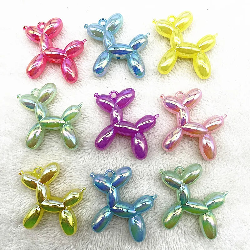 A collection of colorful acrylic balloon dog charms in various shades including pink, blue, yellow, and green.