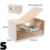 A light wood bird breeding box with a transparent viewing panel and a slanted lid, showing a bird resting on bedding.