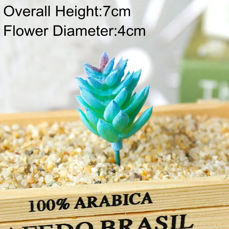Blue artificial succulent plant with a 7cm height and 4cm flower diameter planted in sand.