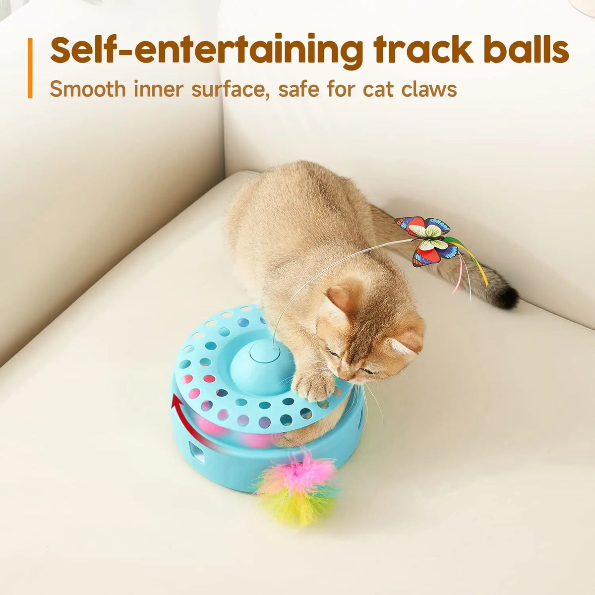 A tabby cat is interacting with a blue track ball toy featuring a fluttering butterfly and feather.