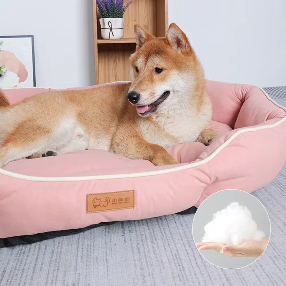 A fluffy Shiba Inu dog is relaxing on a pink corduroy pet sofa bed.