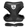 Black adjustable pet harness and leash set with a paw print design