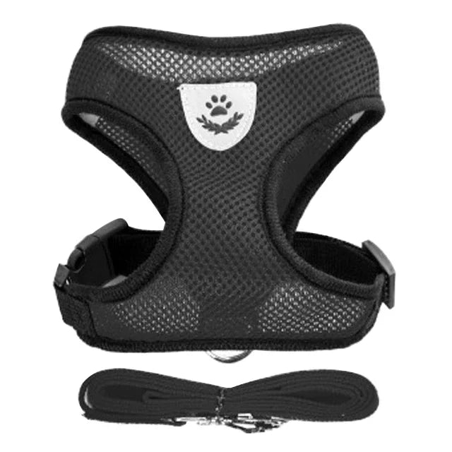 Black adjustable pet harness and leash set with a paw print design