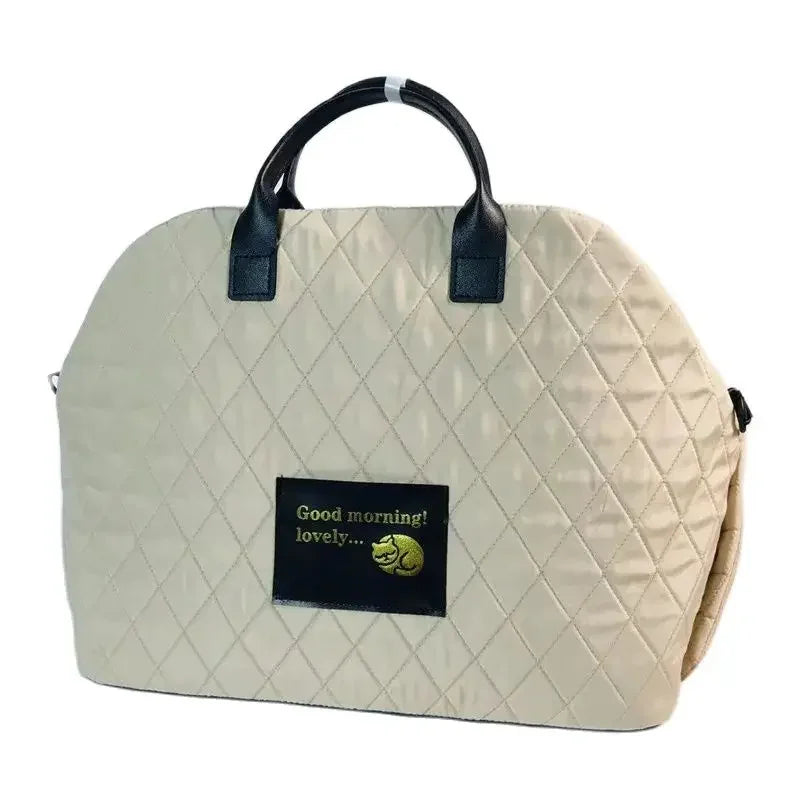 A beige quilted portable soft-sided pet carrier for cats and small dogs with black handles.