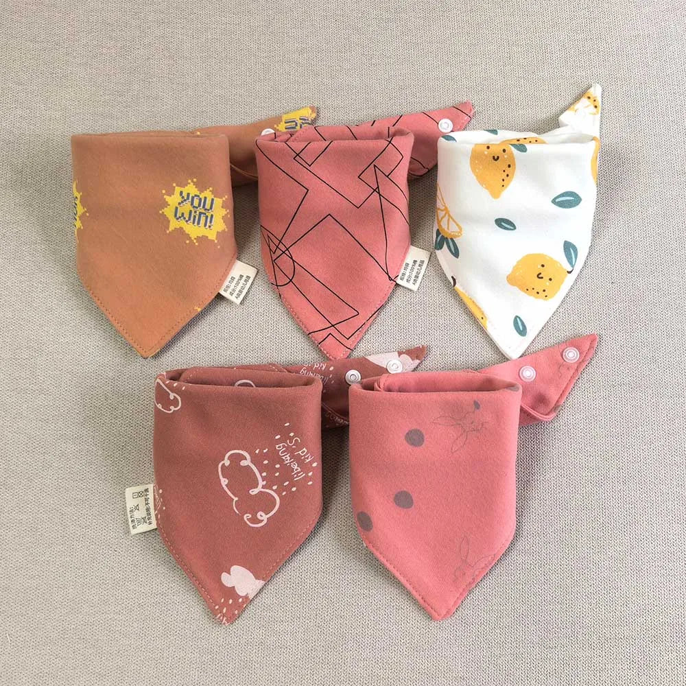 A set of five cotton triangle baby bibs featuring various cartoon prints and designs.