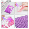 A collection of diamond painting materials including colored beads and a pink tool being used for mosaic art.