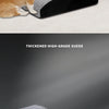 A fluffy orange cat is resting on a thick, gray suede pet ramp.