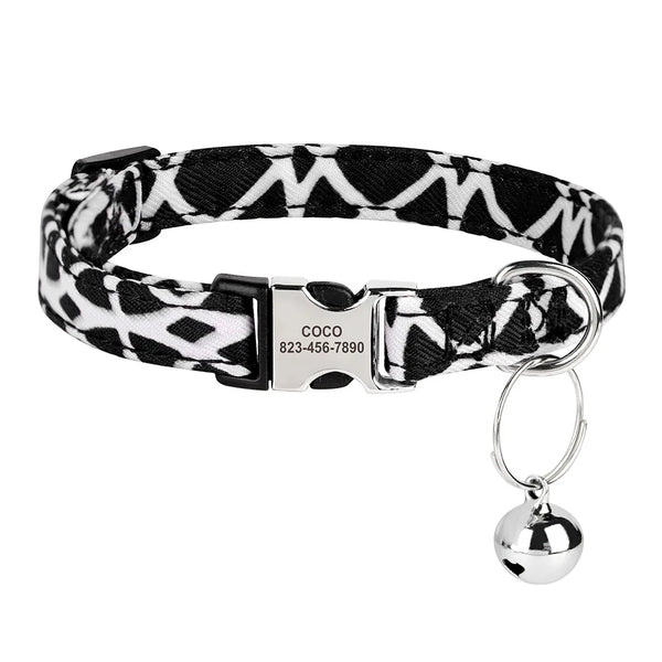 Black and white patterned collar with a silver buckle and attached engraved ID tag.
