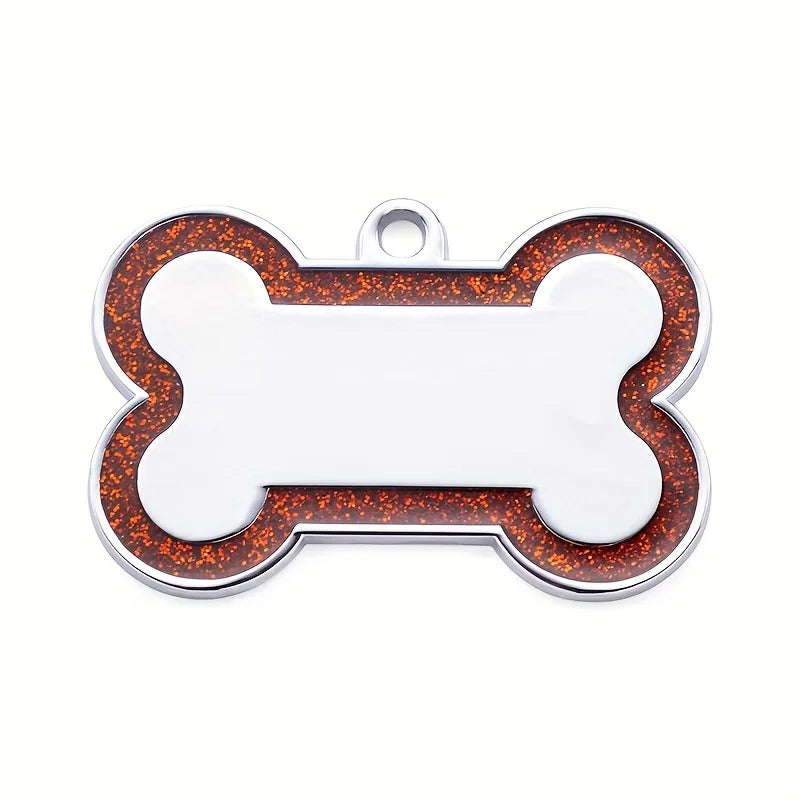 Silver pet ID tag shaped like a bone with an orange glitter border and a loop for a collar.