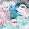 Close-up of pink and light blue laundry items submerged in soapy water with labels indicating fluff, hair, and dander.