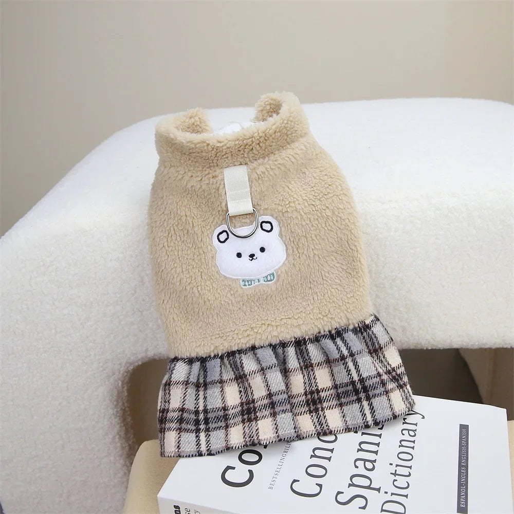 A beige knitted dog dress featuring a plaid fabric trim and a white bear applique.