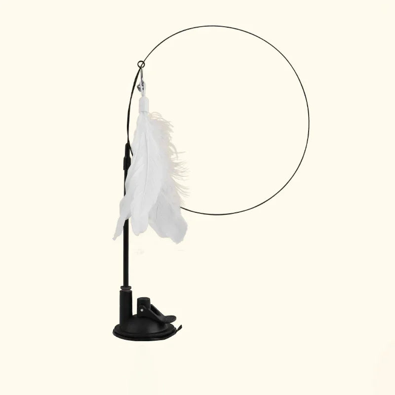 A black interactive feather wand cat toy with a white feather and bell hanging from a circular frame.