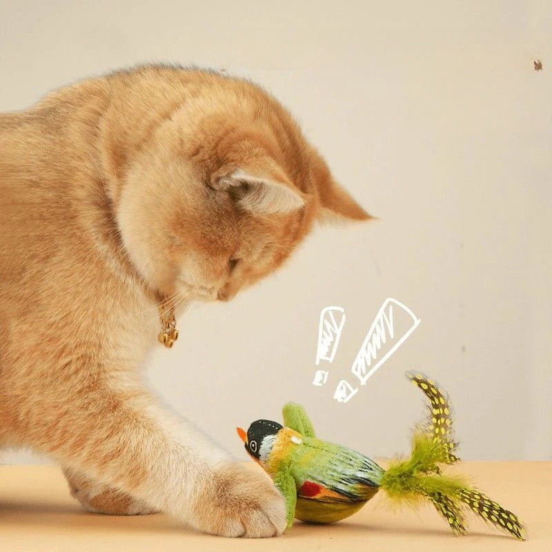 A fluffy ginger cat is interacting with an interactive bird chasing toy.