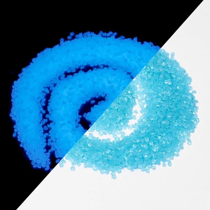 A close-up view of bright blue and cyan glow-in-the-dark decorative pebbles.