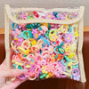 A clear plastic bag filled with colorful elastic hair ties featuring cute cartoon characters and shapes.