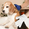A dog is being groomed with a white cleaning glove while wearing a blue sleeve.
